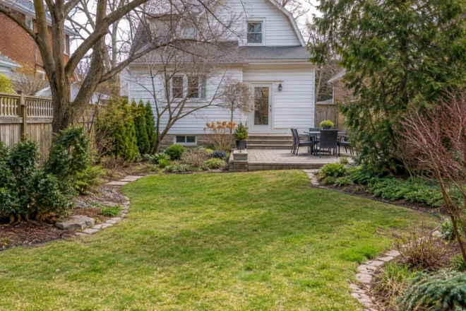 Small backyard lawn cleared of winter twigs