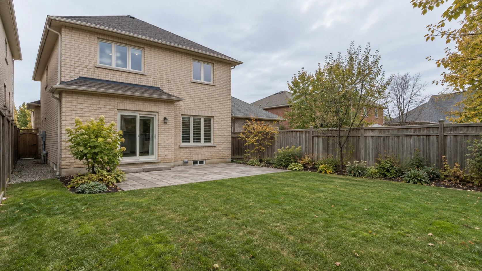 Broad ordinary backyard view showing house, garden, grade and access