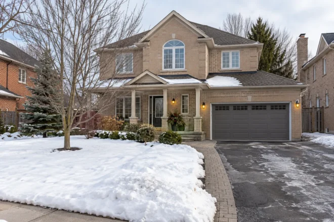 Winter front lawn providing snow-storage space beside a driveway