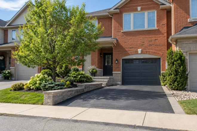 Modest townhouse driveway with a narrow paver addition and retained planting