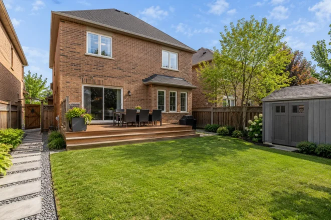 Low backyard deck meeting an open lawn with clear side access